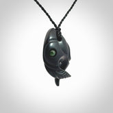 This is a hand carved Black Jade bird head pendant with New Zealand Jade insert. This is a smaller sized necklace and is provided with an adjustable black cord.